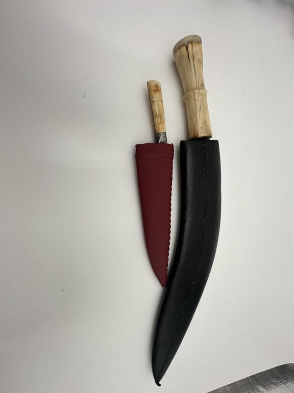 Two 19th dagger Indian Mughal Tribal kard from Indian sub continent. hard carving Northern India: Tribal kard from Indian sub continent. Comes with leather sheath second one bone kukri from Northern India and with hard steel blade and leather sheath .latte one size 43 cm blade 32 cm the small one