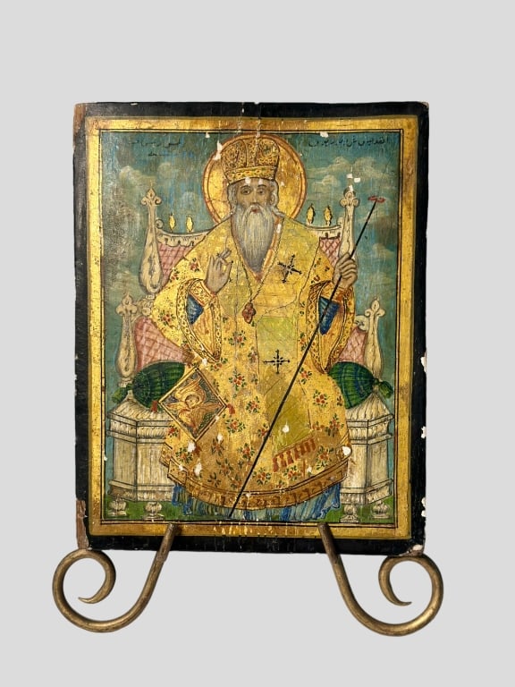 A DATED MELCHITE ICON SHOWING A BISHOP SAINT Syria A DATED MELCHITE ICON SHOWING syria middle east: A DATED MELCHITE ICON SHOWING A BISHOP SAINT Syria, Damascus, dated 1843 Oil on wood panel. The garments made of gold. On the reverse Arabic inscription, dated '1843'. Minor losses, partially restored