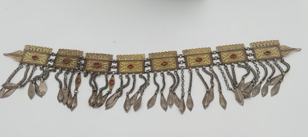 Turkmen Tekke women used to wear high, round, Turkmen Tekke women used to wear high, round,: Turkmen Tekke women used to wear high, round, embroidered bonnets. On the front of these bonnets, underneath the woman?s chin, ornaments such as this one would be attached via soldered-on hooks. The p