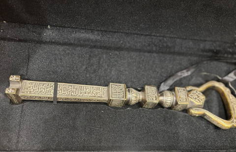 Decorative Replica of the Key to the Holy Kaaba with Arabic Inscriptions koran parts silver inlaid: Decorative Replica of the Key to the Holy Kaaba with Arabic Inscriptions An intricately crafted ceremonial replica of the key to the Kaaba, cast in metal and richly inscribed with Islamic calligraphy.