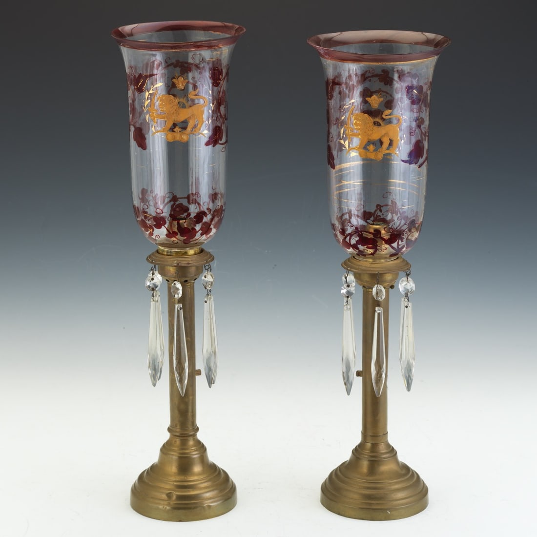 Qajar Dynasty Persian Lustres, ca. Early 19th Century 20"H x 5 ¾"W Pair of Victorian-style: Qajar Dynasty Persian Lustres, ca. Early 19th Century20"H x 5 ¾"WPair of Victorian-style glass mantle lustres, each featuring a hand blown glass hand-painted gilt lion passant before a crown, f