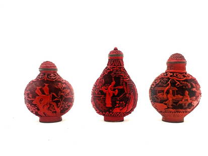 three Chinese Cinnabar lacquer snuff bottles: These are Chinese Cinnabar lacquer snuff bottles, intricately hand-carved and typically dating from the late Qing Dynasty to early 20th century. Cinnabar is a red-colored lacquer applied in many layer
