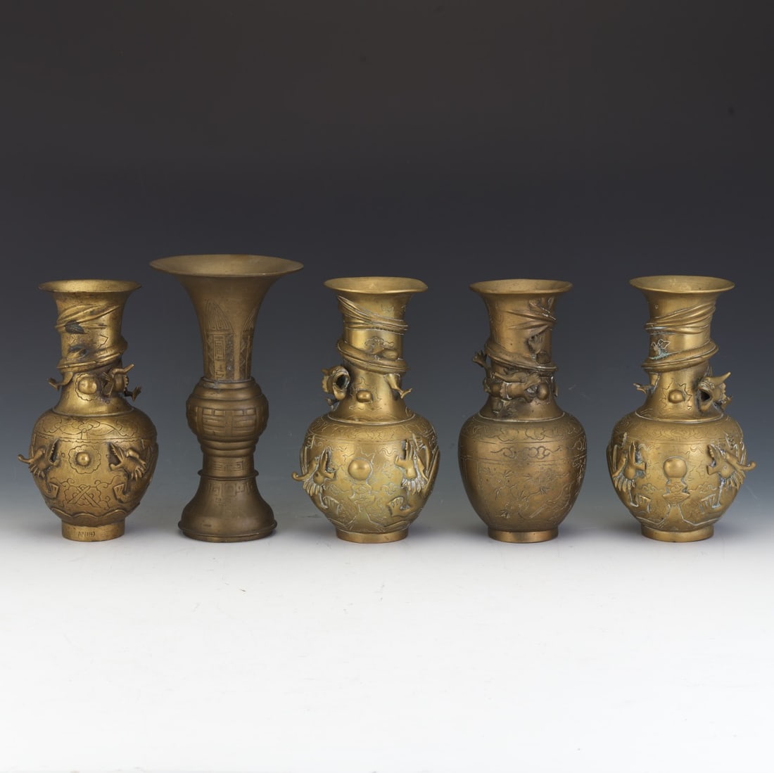 five Chinese brass temple vases, each of varying baluster and gu-form design (1 of 5)