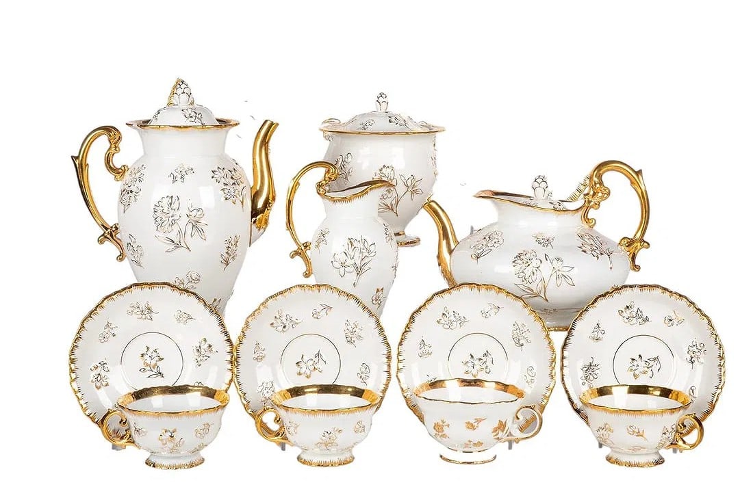 MEISSEN WHITE AND GOLD PORCELAIN TEA SET Twenty-nine piece Meissen tea set on white ground with gilt: Twenty-nine piece Meissen tea set on white ground with gilt flowers throughout. Including twelve teacups and matching saucers, two dinner plates, one creamer, one covered sugar bowl, one coffee pot, a