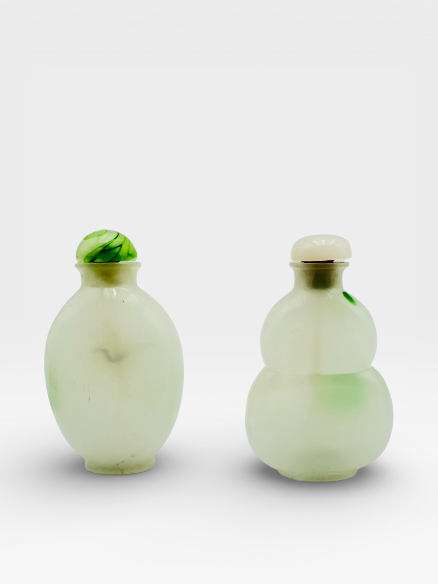 Pair of Jade Snuff Bottles A finely worked pair of Chinese jade snuff bottles, each carved from pale (1 of 4)