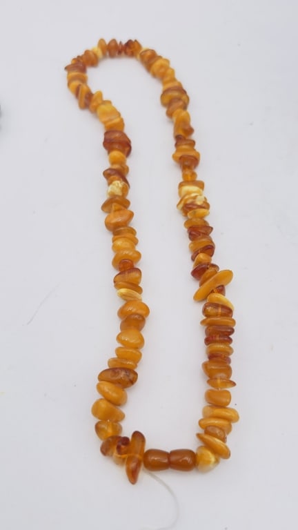 Baltic Amber Nugget Bead Necklace A naturalistic necklace composed of large irregular Baltic amber: A naturalistic necklace composed of large irregular Baltic amber nugget beads in shades ranging from golden honey to milky butterscotch and deep cognac. The beads are polished yet retain their organic