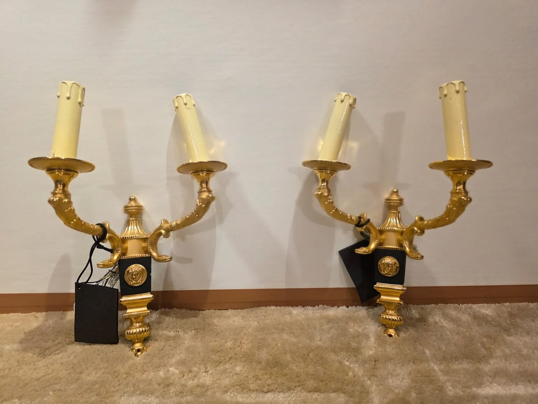 Pair of Gianni Versace Home Gilt Bronze Wall Sconces, Medusa Motif: A striking pair of Gianni Versace Home two-light wall sconces, executed in gilt bronze with blackened architectural elements, prominently featuring the iconic Medusa roundel—a signature emblem of th