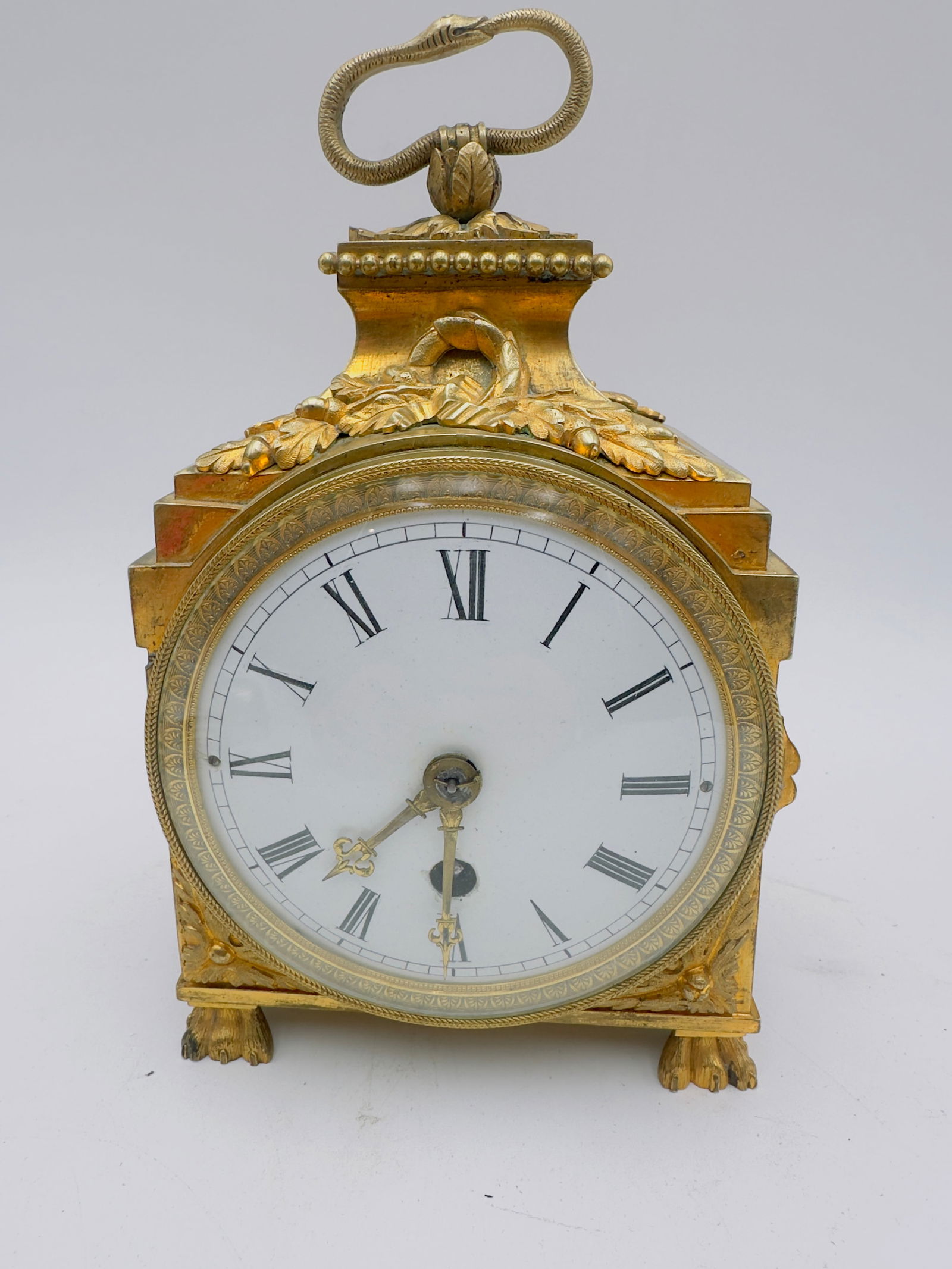 lenzkirch million clock price bronze officers bronze: Gilt bronze. Straight, rectangular case with applied foliage and large rosette motifs on the sides, resting on flattened feet. The upper section rises in a curved shape with an oak leaf wreath and a h