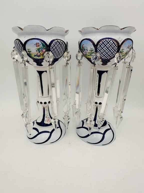 A fine pair of Bohemian glass mantel lustres, richly decorated in cobalt blue and white enamel: A fine pair of Bohemian glass mantel lustres, richly decorated in cobalt blue and white enamel with hand-painted floral reserves and gilt detailing. Each features a scalloped rim and is adorned with a