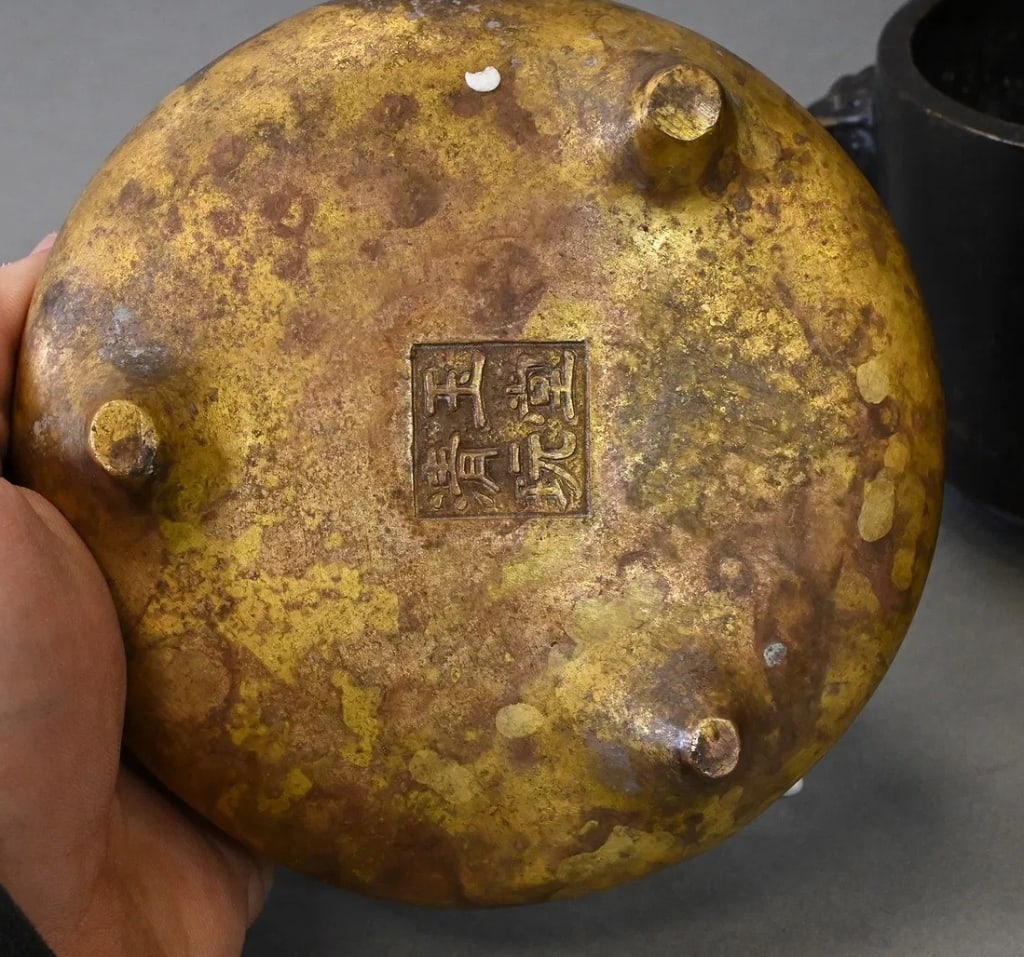 Chinese bronze censer of compressed globular form with two upright loop handles and raised on (1 of 3)