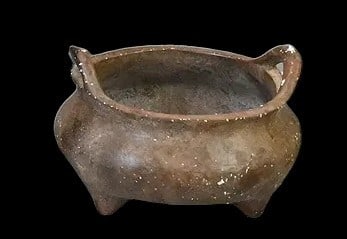 Chinese Bronze Tripod Censer with Xuande Style MarkCast bronze censer of compressed globular form: Chinese Bronze Tripod Censer with Xuande Style MarkCast bronze censer of compressed globular form with two upright loop handles and raised on three short feet. The vessel displays a dark brown surface