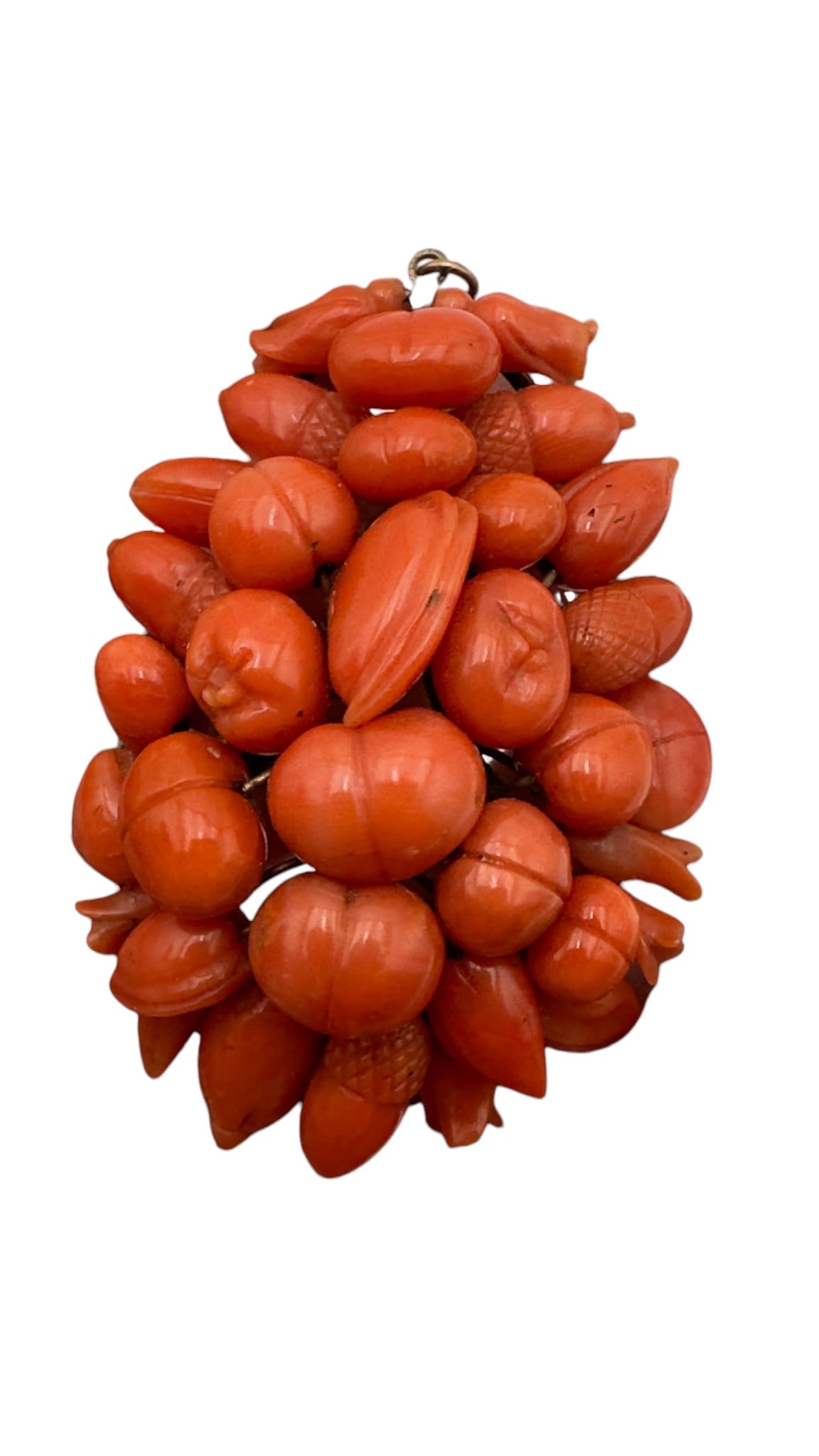 Decorative cluster pendant composed of numerous carved red coral fruit and berry forms mounted on: Decorative cluster pendant composed of numerous carved red coral fruit and berry forms mounted on a metal armature. The individually carved coral elements are arranged in a three-dimensional bouquet