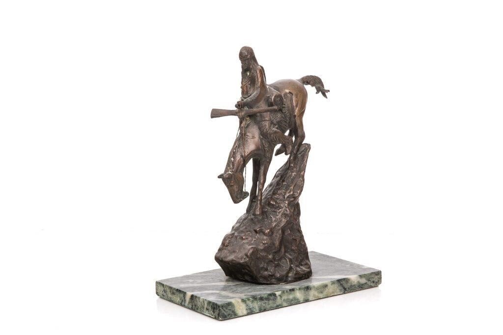 patinated bronze casting of Frederic Remington's 'The Mountain Man' set on a green marble base. (1 of 4)