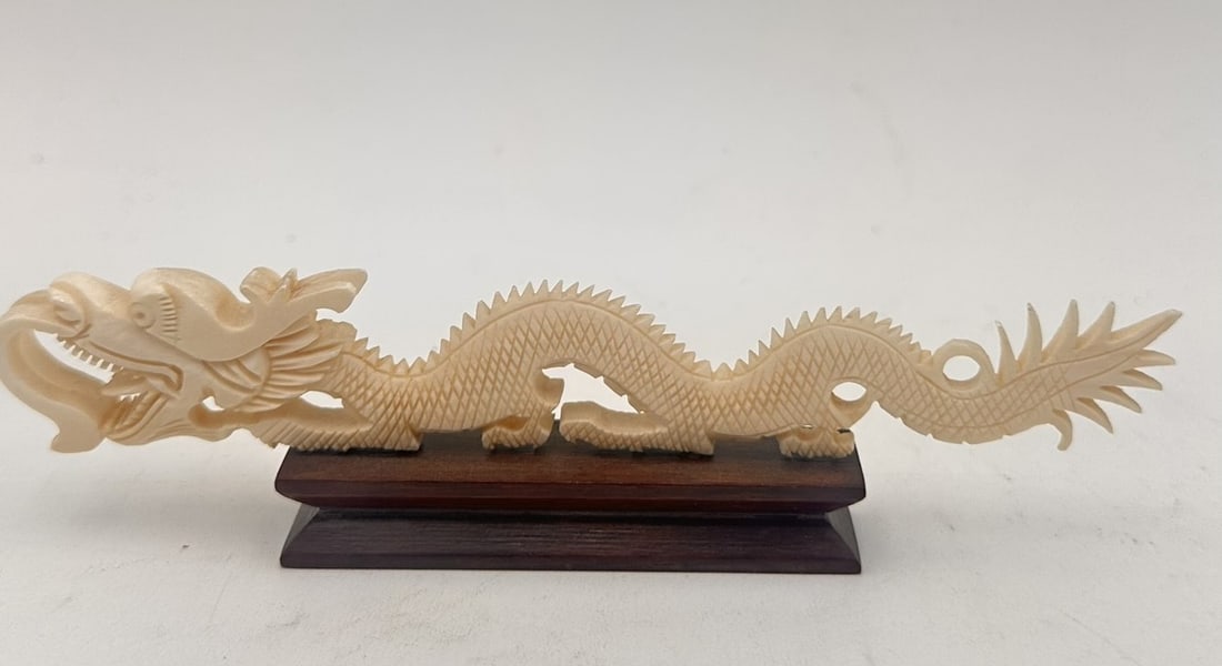 Chinese Carved Dragon on Stand, Early 20th Century Finely carved in the form of a sinuous: Chinese Carved Dragon on Stand, Early 20th Century Finely carved in the form of a sinuous dragon with detailed scales, flowing mane, and open mouth revealing teeth, symbolizing imperial power and good