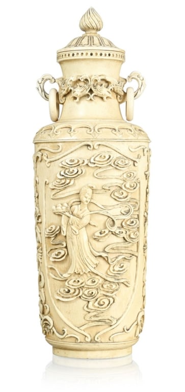 Finely carved Asian lidded vase executed in elongated baluster form with fitted domed cover and: Finely carved Asian lidded vase executed in elongated baluster form with fitted domed cover and finial. The exterior is richly decorated in high relief with a flowing female figure floating among scro