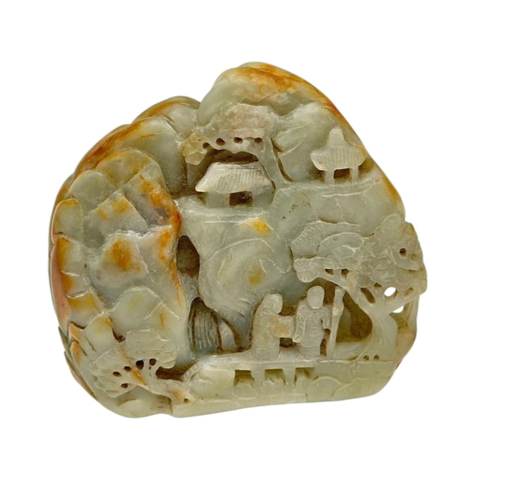 Finely carved pale celadon nephrite jade depicting a mountainous landscape scene. The carving (1 of 2)