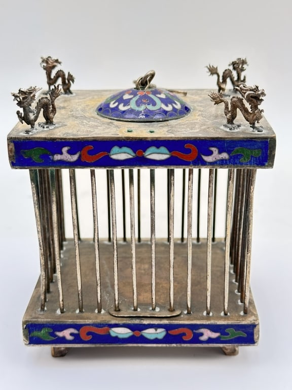 A rare and decorative Chinese metal bird cage, featuring square architectural form with vertical: A rare and decorative Chinese metal bird cage, featuring square architectural form with vertical metal bars and enriched with cloisonn? enamel panels in vivid cobalt blue, decorated with scrolling flo