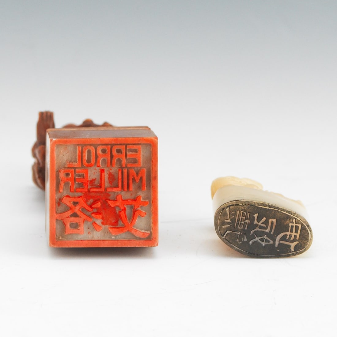 Two Chinese Hard Stone Chops with tin seal in red fabric covered box, overall 1?" x 3" x 8";: Two Chinese Hard Stone Chops with tin seal in red fabric covered box, overall 1?" x 3" x 8"; together with smaller chop depicting a foo lion (1?" x 1" x?") in box, overall 1?" x 2?" x 2?".