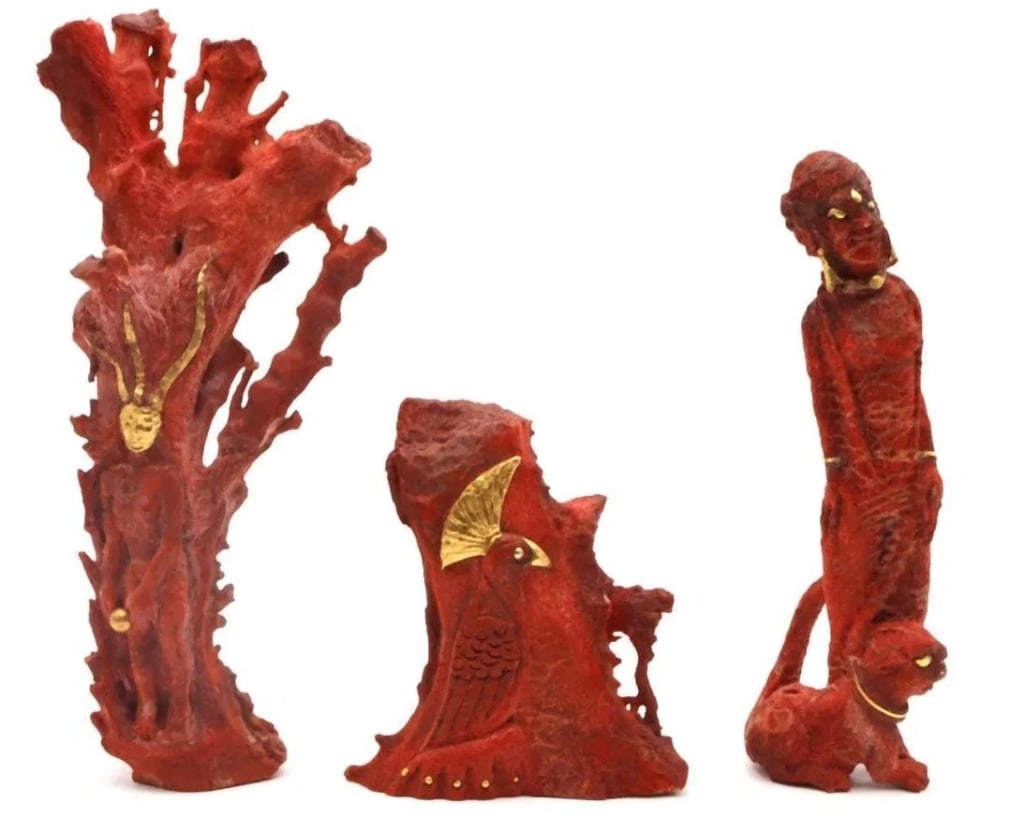 Set of Three African-Inspired Red Coral Sculptures with Gilded Details ? 20th Century A striking: Set of Three African-Inspired Red Coral Sculptures with Gilded Details ? 20th Century A striking trio of sculptural art pieces, each uniquely crafted in a red coral-style