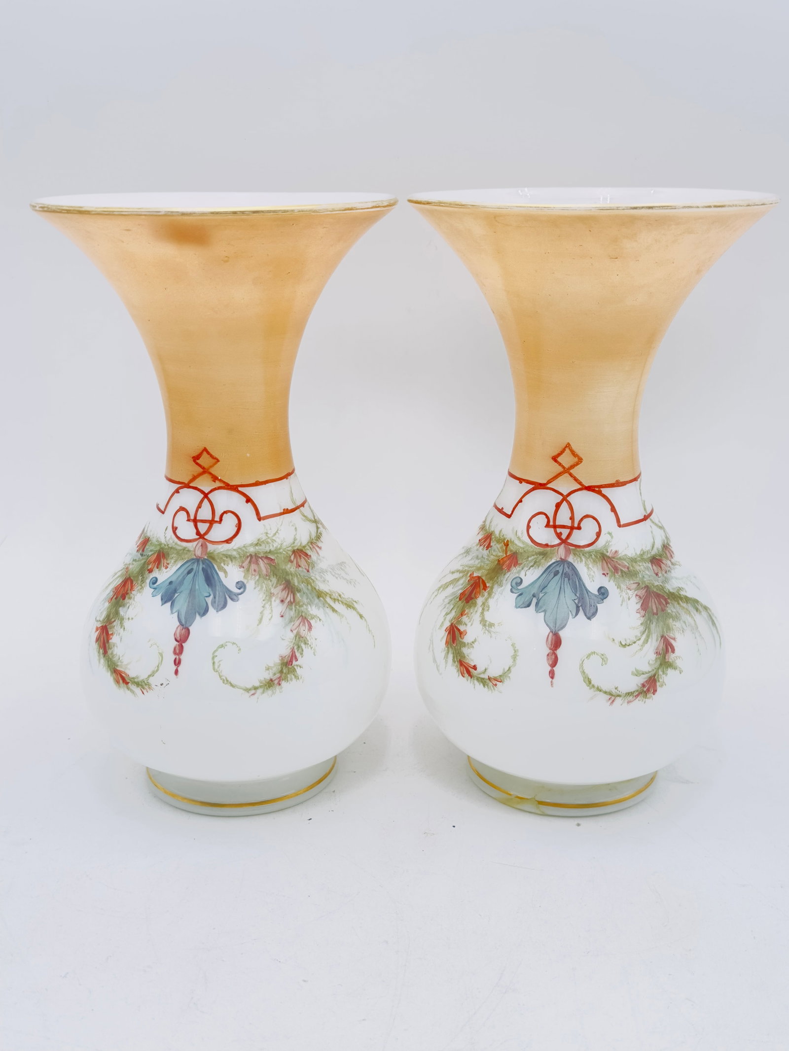 Pair of White Opaline Vases with Floral Decoration: Pair of White Opaline Vases with Floral DecorationPair of white opaline vases with flared necks, decorated with floral compositions, bouquets, and polychrome garlands framed in pale