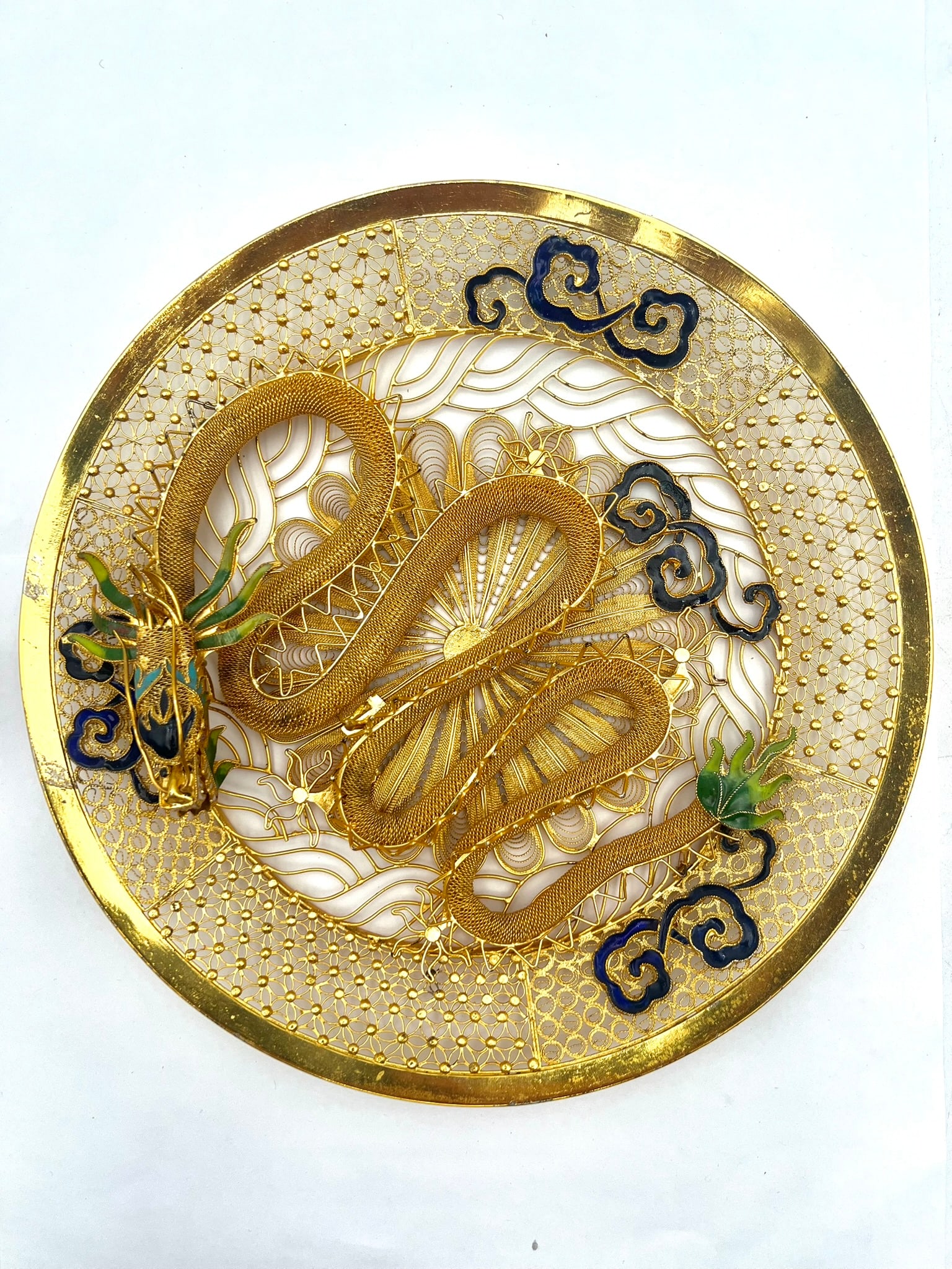Chinese Gilt Filigree Dragon Decorative Plate, 20th Century: A fine Chinese gilt filigree decorative plate featuring an intricately hand-worked coiled dragon in high relief at the center. The piece is richly adorned with delicate openwork filigree, stylized