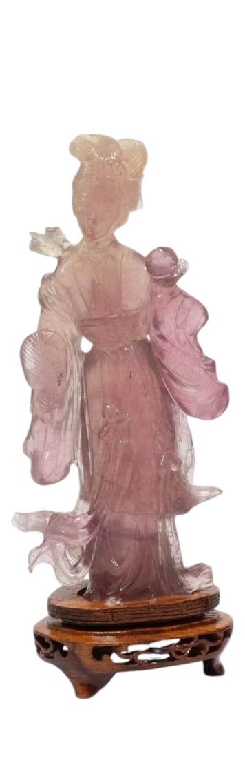 A Chinese carved pink hardstone figure depicting a standing lady in flowing robes. The figure is (1 of 2)