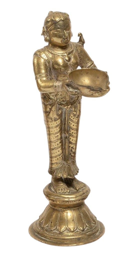 An Indian brass figure depicting a standing female attendant holding a bowl with both hands. The (1 of 3)