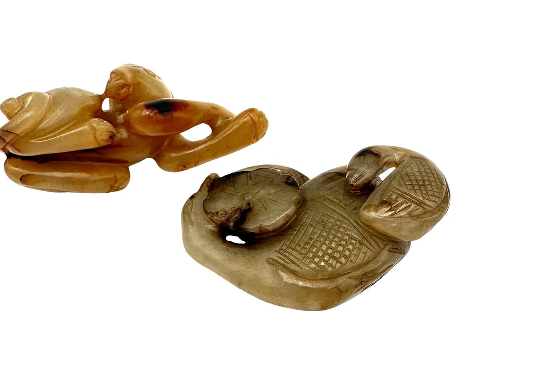 Two Chinese jade animal carvings. Comprising:A russet and honey-toned jade carving of a monkey, (1 of 6)