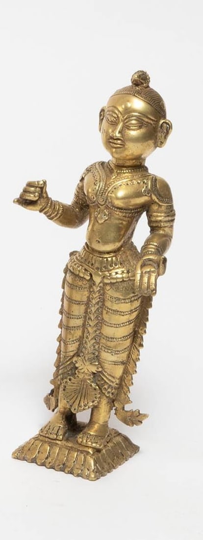 An Indian brass figure depicting a standing female deity in traditional attire. The figure is (1 of 3)