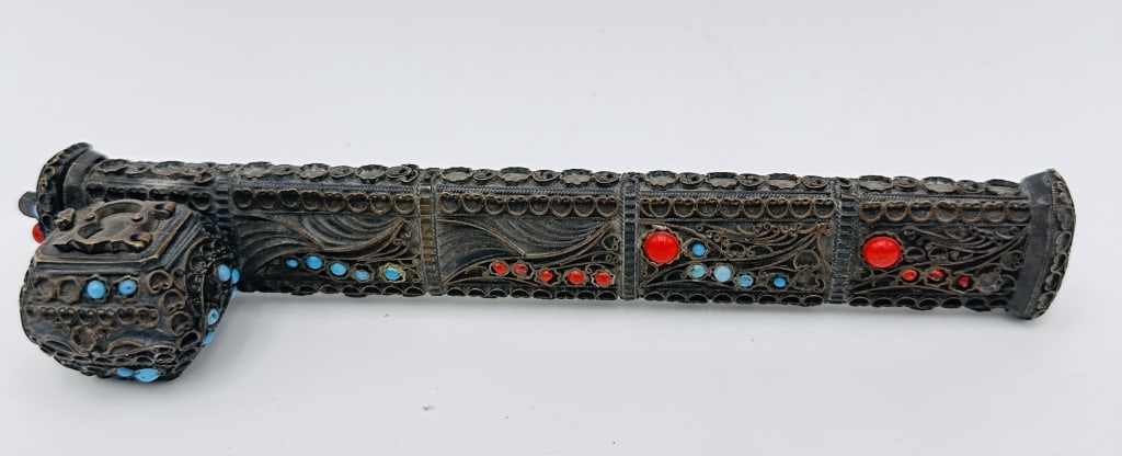 An ornate filigree case, crafted in darkened silver (possibly silver alloy or plated): An ornate filigree case, crafted in darkened silver (possibly silver alloy or plated), the surface decorated with intricate hand-worked openwork filigree designs and set with inset cabochons of red co