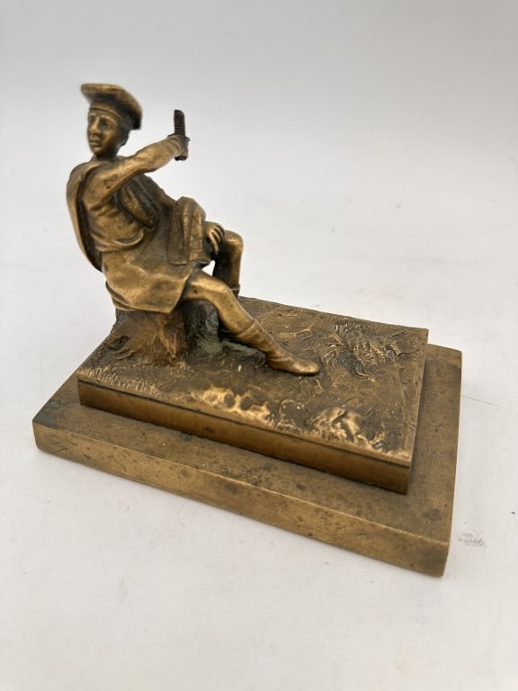 Bronze Figural Sculpture of a Seated ManA finely cast bronze sculpture depicting a seated man in: Bronze Figural Sculpture of a Seated ManA finely cast bronze sculpture depicting a seated man in traditional attire, resting on a naturalistic base. The figure, wearing a draped garment and boots, sit