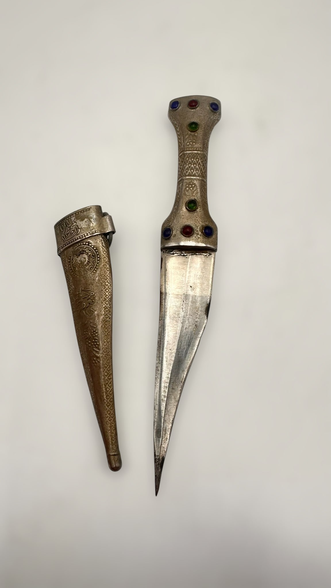 A Middle Eastern dagger sheath, likely for a jambiya, of elongated tapering form, constructed with (1 of 9)