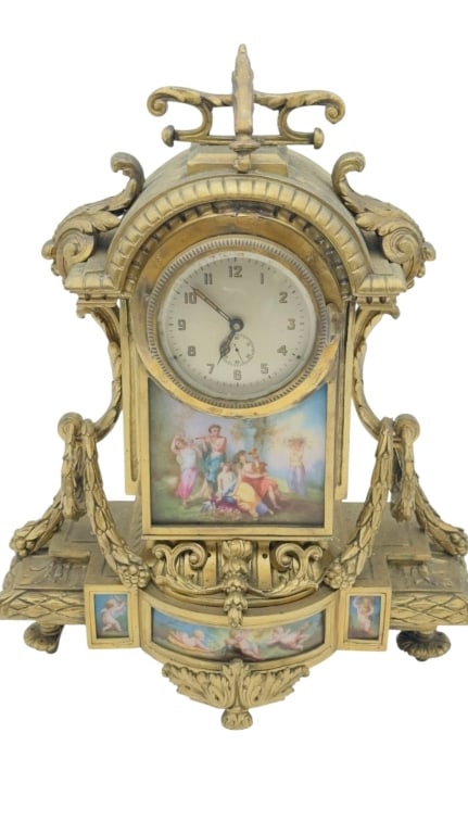 A finely cast gilt metal mantel clock of ornate Neoclassical inspiration, featuring an arched case: A finely cast gilt metal mantel clock of ornate Neoclassical inspiration, featuring an arched case surmounted by a decorative finial and flanked by scrolling acanthus-form mounts and draped garlands. 