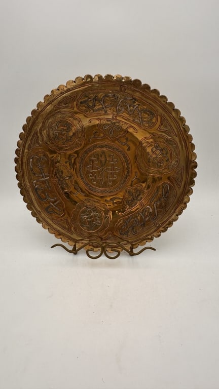 A finely decorated Islamic brass plate of circular form with a scalloped rim, featuring intricate (1 of 4)