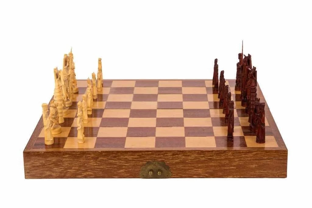 A finely carved Chinese ivory chess set comprising natural and stained ivory pieces, each: A finely carved Chinese ivory chess set comprising natural and stained ivory pieces, each depicting figures, pagodas, and traditional motifs. The set is housed in a fitted wooden case lined with blue 