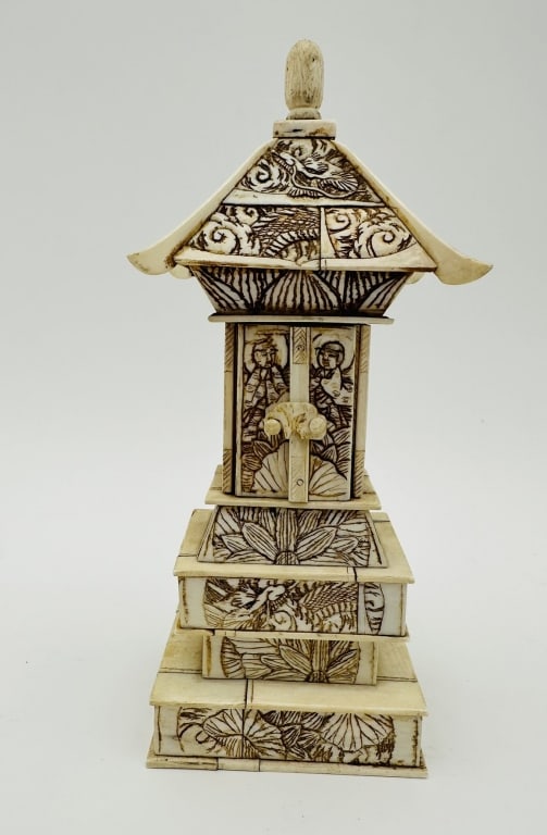 Finely carved Asian miniature shrine or pagoda-form sculpture, executed and assembled in: Finely carved Asian miniature shrine or pagoda-form sculpture, executed and assembled in architectural tiers. The exterior surfaces are richly engraved with traditional motifs including dragons, lotus