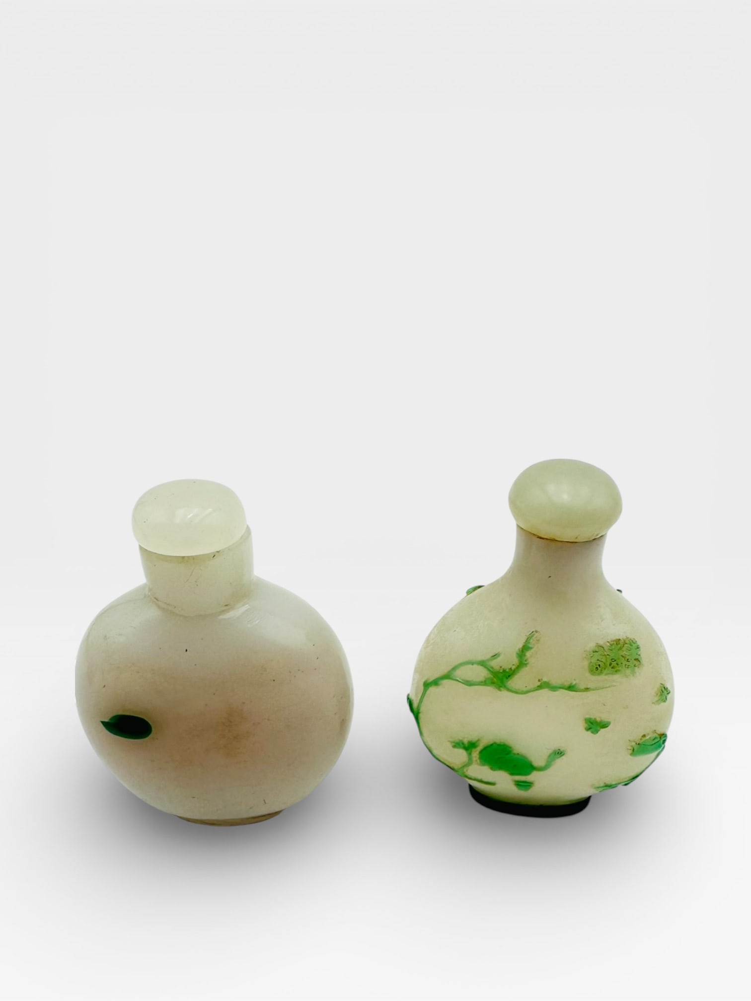 A well-carved pair of Chinese jade snuff bottles, each fashioned from pale celadon jade with (1 of 5)