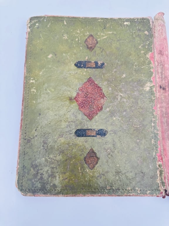 Antique Islamic Manuscript Binding Region: Likely Persia (Iran) or Ottoman Empire Date: Estimated: Antique Islamic Manuscript Binding Region: Likely Persia (Iran) or Ottoman Empire Date: Estimated 17th?19th century CE Material: Tooled and stamped leather over boardFeatures:Green leather cover,