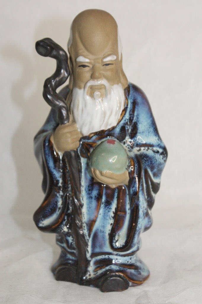 Chinese Vintage Porcelain Doll Statue holding a wooden stick and crystal ball. This is a Buddhist: Chinese Vintage Porcelain Doll Statue holding a wooden stick and crystal ball. This is a Buddhist master who is considered to be wise and knowledgeable. 18 CM HIGH For condition report please contact 