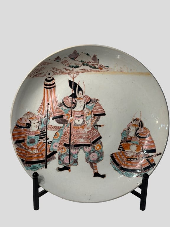 A finely hand-painted Japanese Kutani porcelain charger depicting three samurai warriors in (1 of 2)