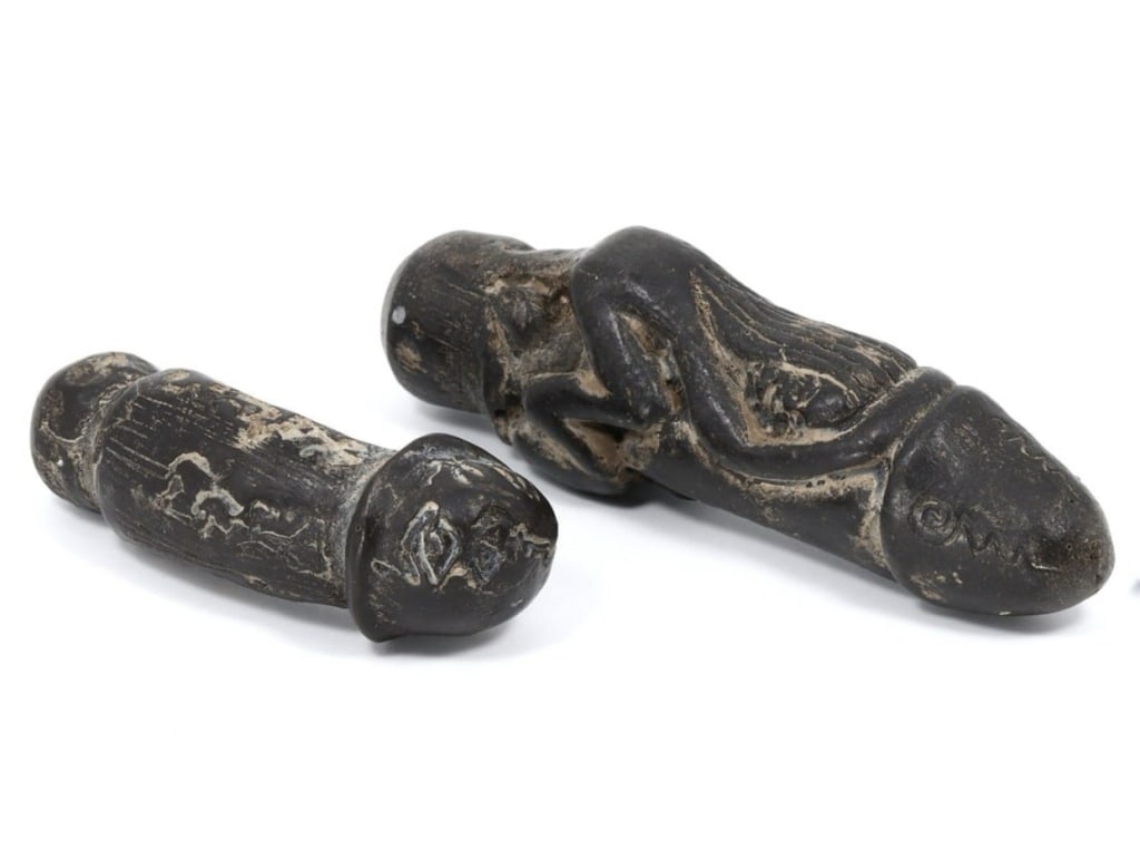 This intriguing lot features two ancient phallic amulets made from wood, each measuring between (1 of 1)