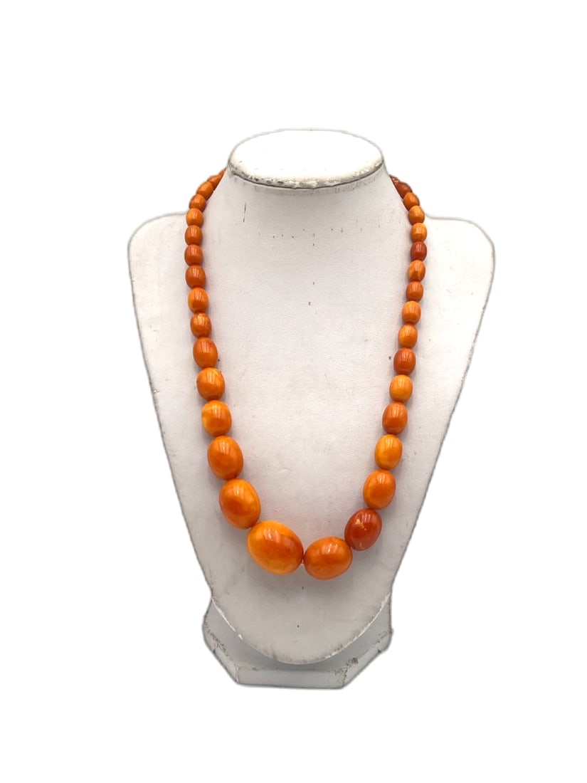 Vintage Butterscotch Amber Graduated Bead Necklace: Vintage necklace composed of graduated butterscotch amber-tone beads in warm honey and caramel hues, displaying subtle marbling and a polished finish. The beads vary in size, increasing toward the cen