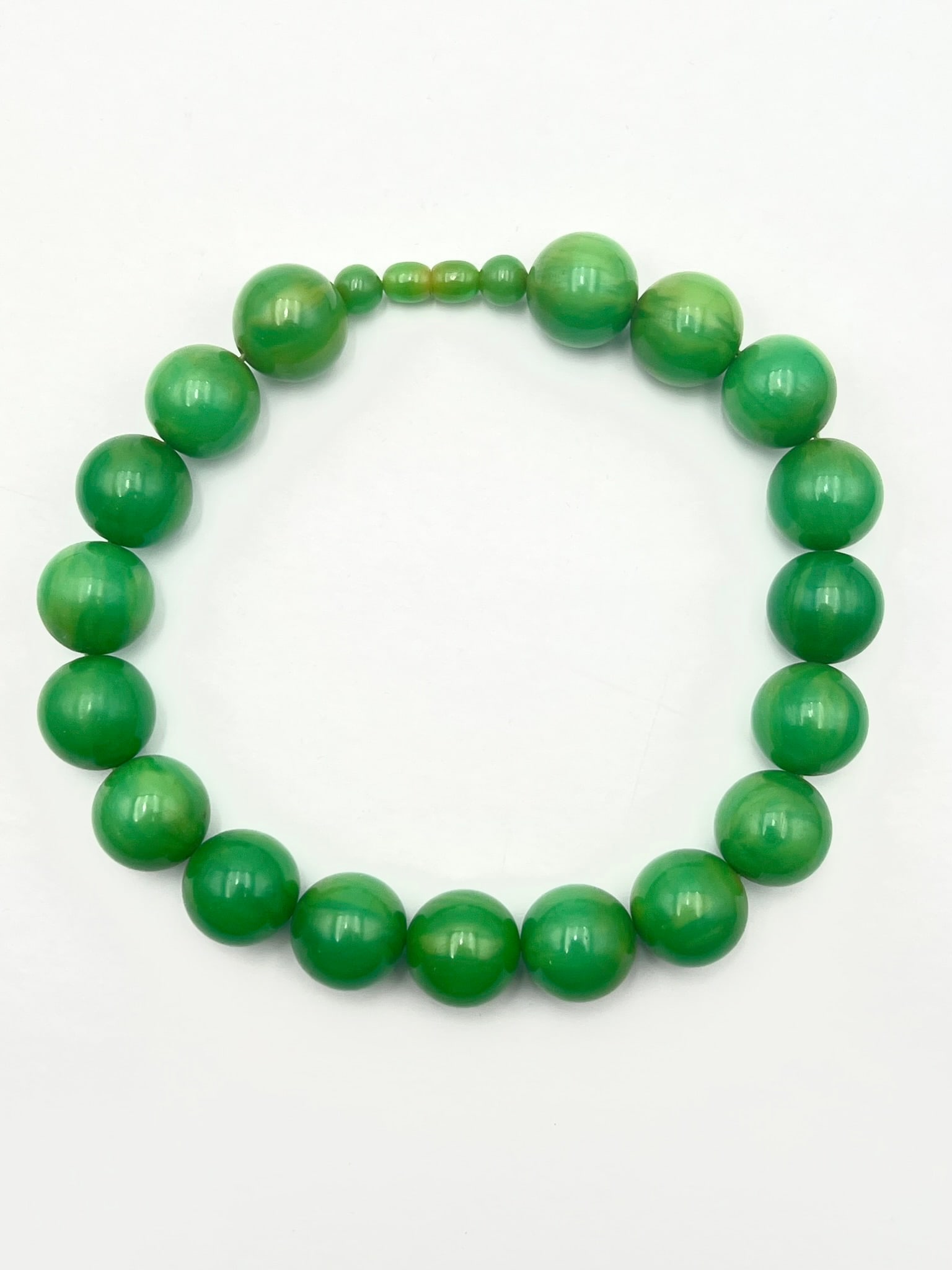 Vintage Bakelite Green Marbled Bead Strand / Prayer Beads: Vintage Bakelite bead strand composed of large graduated spherical beads in rich green tones with attractive marbled swirls and polished finish. The beads display varied translucency and swirling colo