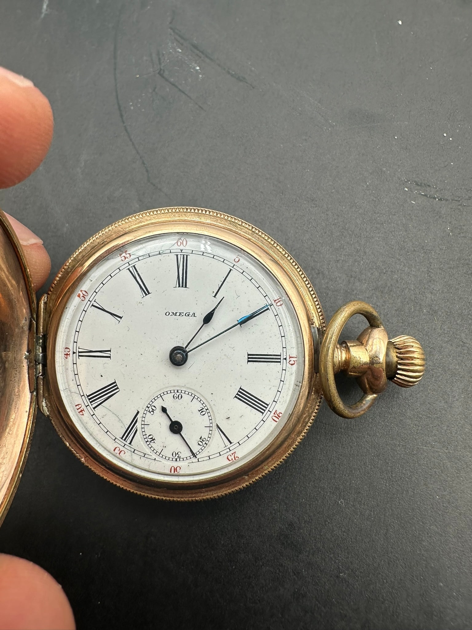 Omega Hunter Case Pocket Watch, Early 20th Century 14k (25 years ): An antique Swiss Omega open-face pocket watch dating to the early 20th century, housed in an engraved gold-filled case with an elegant floral motif. The white enamel dial features black Roman numerals