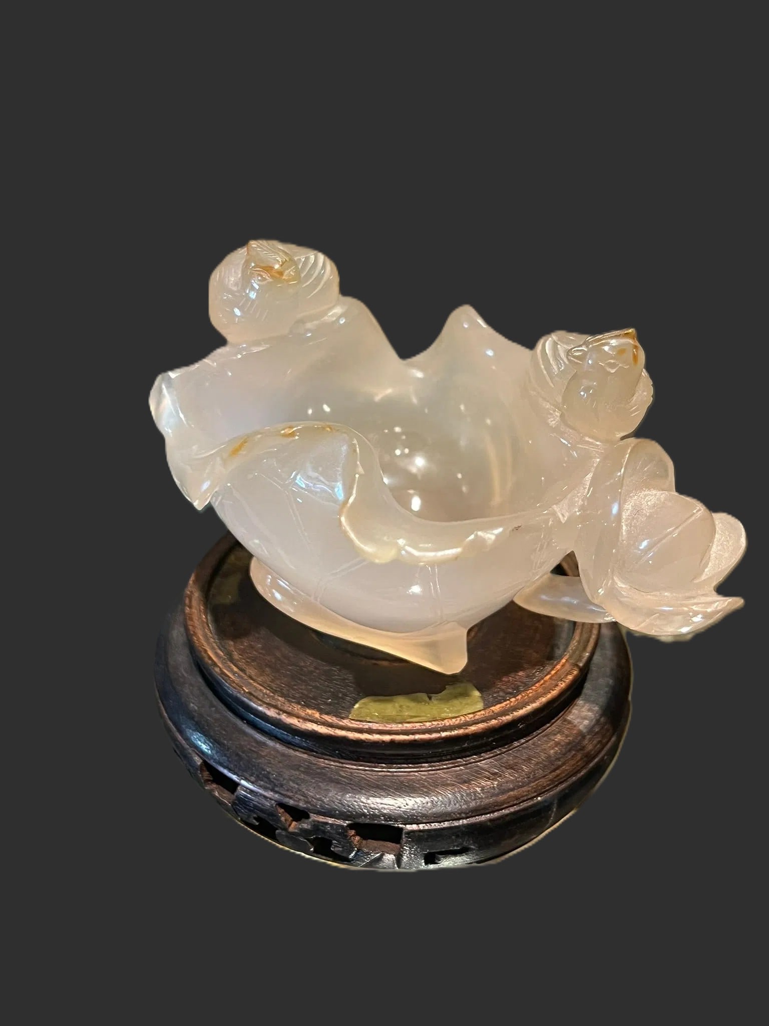 An Agate Lotus-Form Washer, Qing Dynasty, 19th Century: A finely carved agate washer of lotus form, rendered in translucent pale cream to clear hardstone with natural cloudy inclusions. The vessel is sculpted with flowing petal-form edges and adorned with 