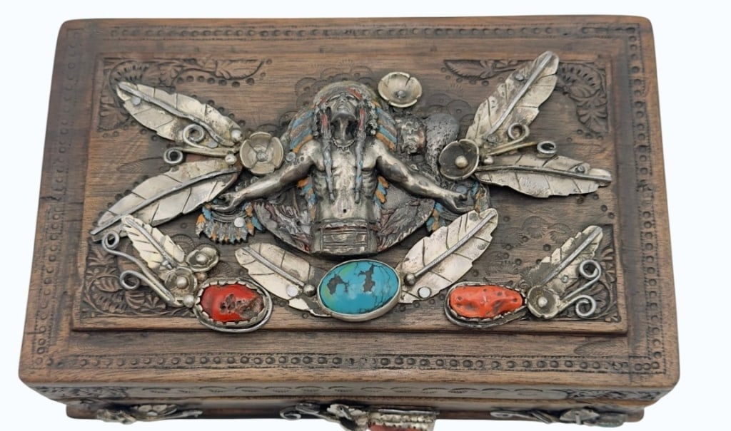 Handmade Native American Style Wooden Jewelry Boxt A handmade Native American style wooden jewelry: A handmade Native American style wooden jewelry box of rectangular form. The lid features intricate applied metalwork depicting a central figure, surrounded by southwestern motifs including feathers a