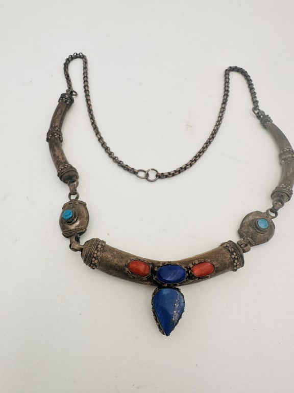 Vintage Tibetan Silver Necklace with Gemstones Vintage Tibetan Silver Necklace with GemstonesA: Vintage Tibetan Silver Necklace with GemstonesA handcrafted Tibetan necklace made entirely of silver, featuring ornate repouss? and filigree work. Set with natural cabochon gemstones including lapis l