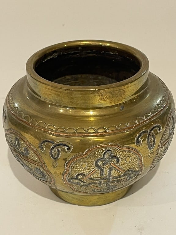 AN EGYPTIAN CAIROWARE SILVER AND COPPER-INLAID BRY An Egyptian Cairoware brass bowl, circa: An Egyptian Cairoware brass bowl, circa 1880?1900, of compressed globular form with a short cylindrical neck and circular foot. The body finely engraved and decorated with shaped cartouches containing