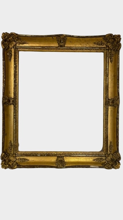 AN ORNATE GILT GESSO AND WOOD PICTURE FRAME, 19THY A decorative antique picture frame of rectangular: A decorative antique picture frame of rectangular form, with richly ornamented gilt gesso decoration featuring scrolling acanthus leaves, floral motifs and raised corner embellishments. The broad text
