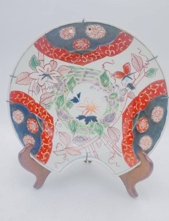 Japanese Imari Porcelain Charger, Edo Period (18th A finely decorated Japanese Imari porcelain: A finely decorated Japanese Imari porcelain charger, featuring a vibrant polychrome palette of iron-red, cobalt blue, and green enamels. The central medallion is adorned with stylized floral motifs fr